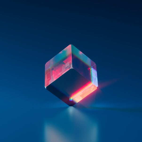 A glass cube balancing on its edge.